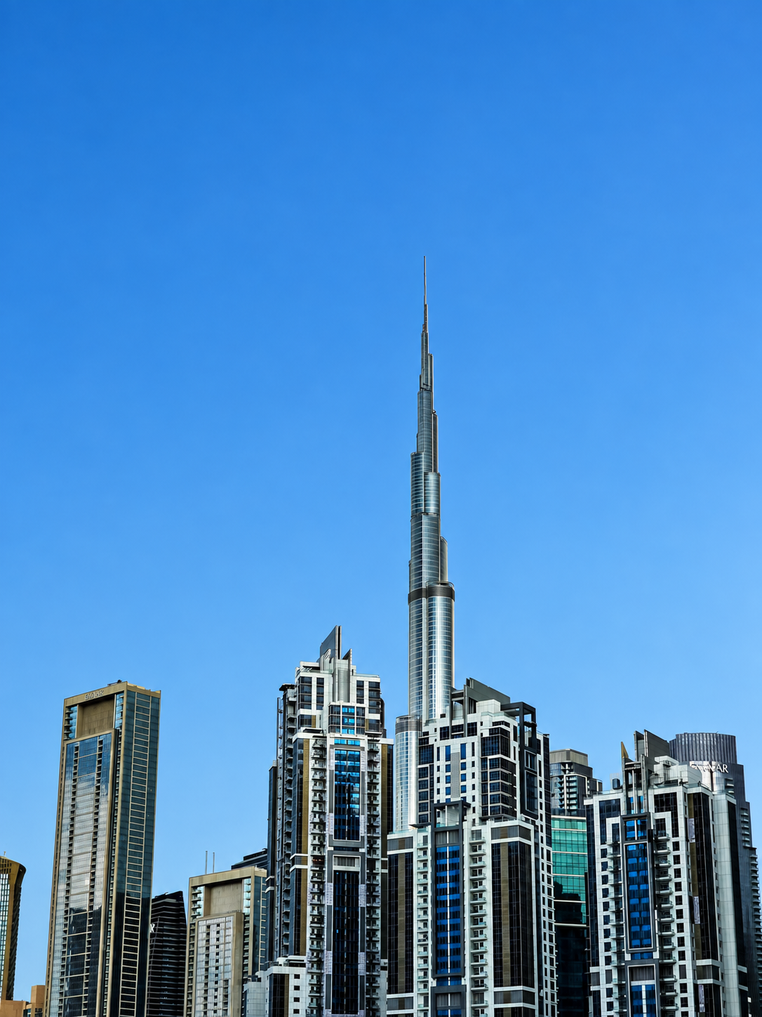 Burj Khalifa and the Downtown Dubai skyline beneath a clear blue sky